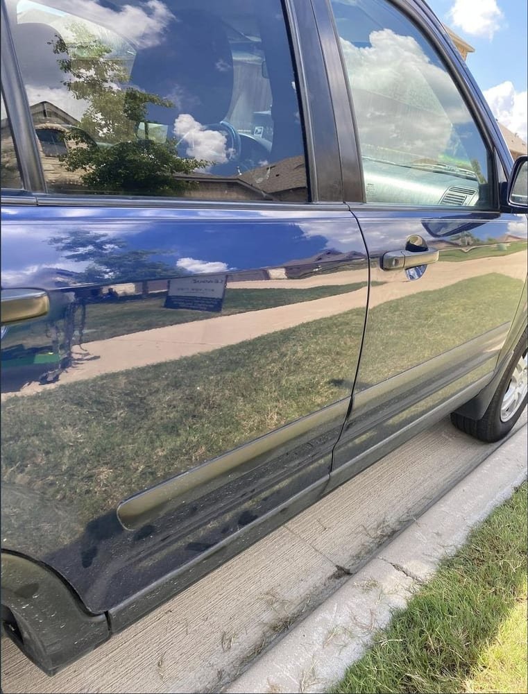 The same rear door panel after the dent was removed
