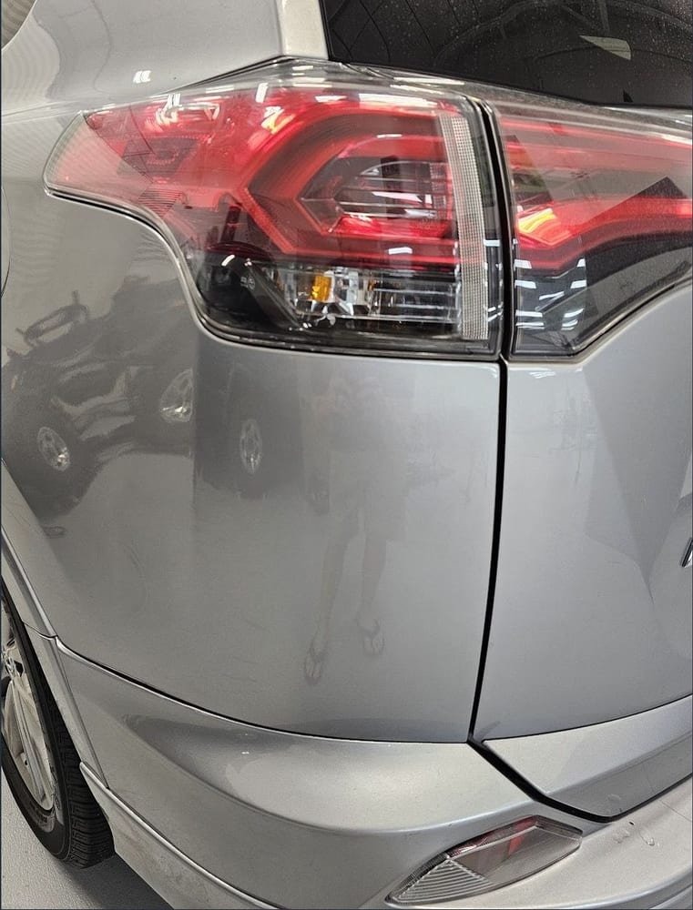 The same rear quarter panel after repair, smooth with no dent