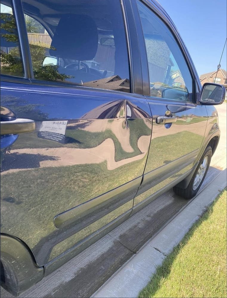 Dented rear door panel before repair